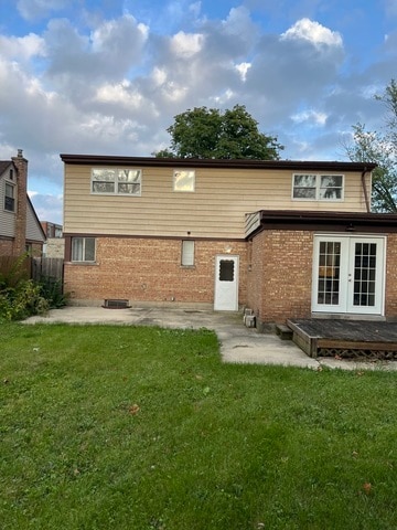 back of house with a patio area, a yard, and french doors