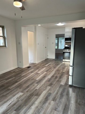 kitchen with white cabinetry, dark hardwood / wood-style flooring, ceiling fan, and appliances with stainless steel finishes