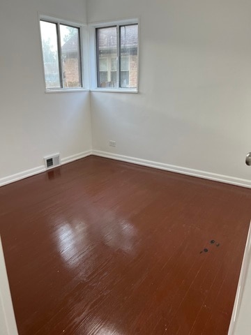 spare room with hardwood / wood-style floors