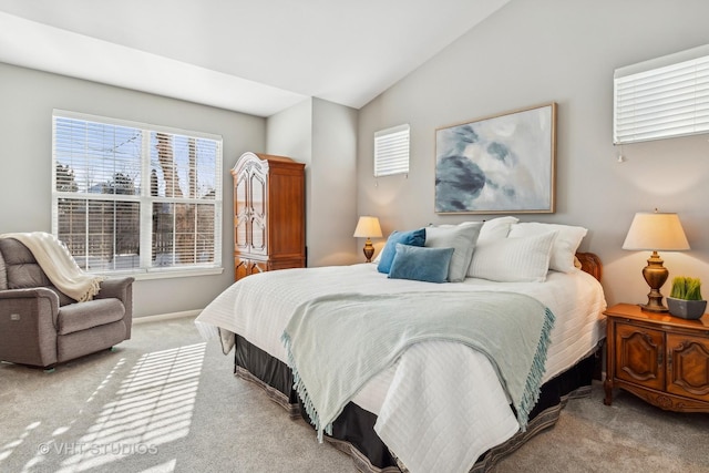 bedroom with light colored carpet and vaulted ceiling