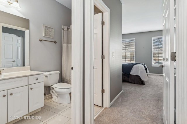 bathroom with toilet, vanity, and curtained shower