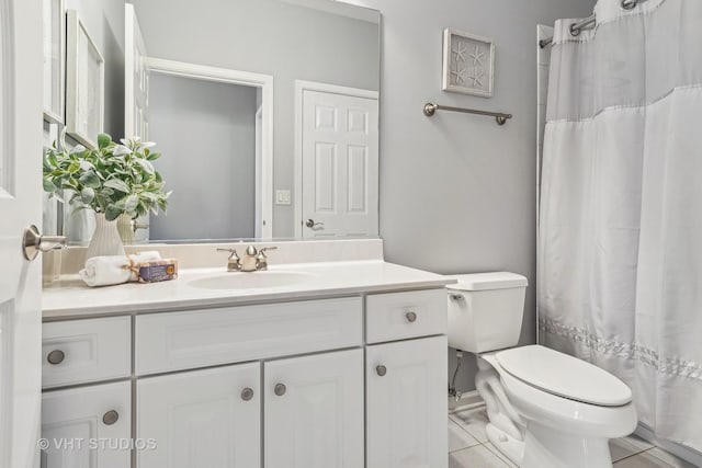 bathroom with toilet, tile patterned floors, and vanity