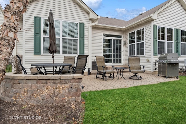 rear view of house featuring a lawn and a patio