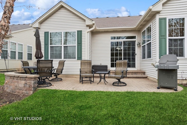 back of house with a patio area and a yard