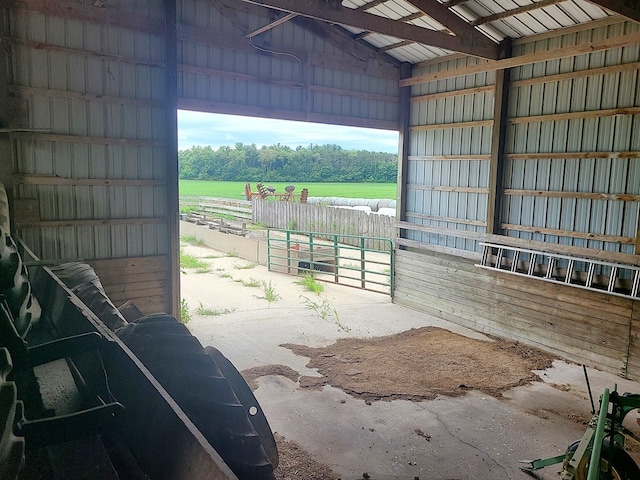 view of horse barn featuring a rural view