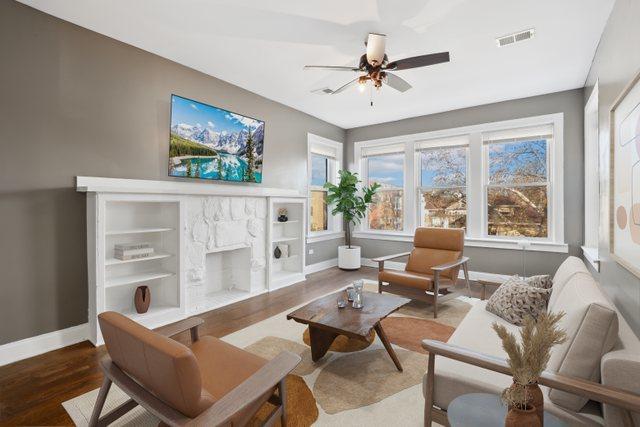 living room with wood-type flooring and ceiling fan