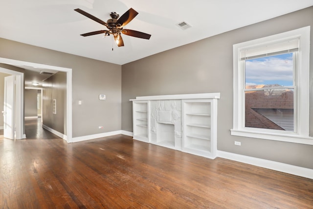 unfurnished living room with ceiling fan and dark hardwood / wood-style flooring