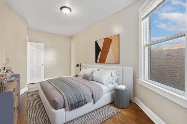 bedroom with hardwood / wood-style floors