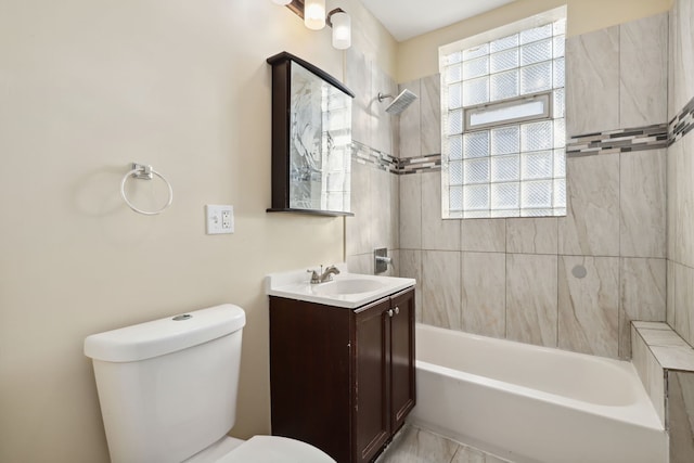 full bathroom with vanity, tiled shower / bath combo, and toilet