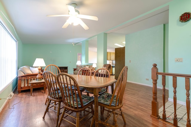 dining area featuring hardwood / wood-style floors, ceiling fan, and lofted ceiling