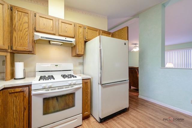 kitchen with light wood-type flooring and white appliances