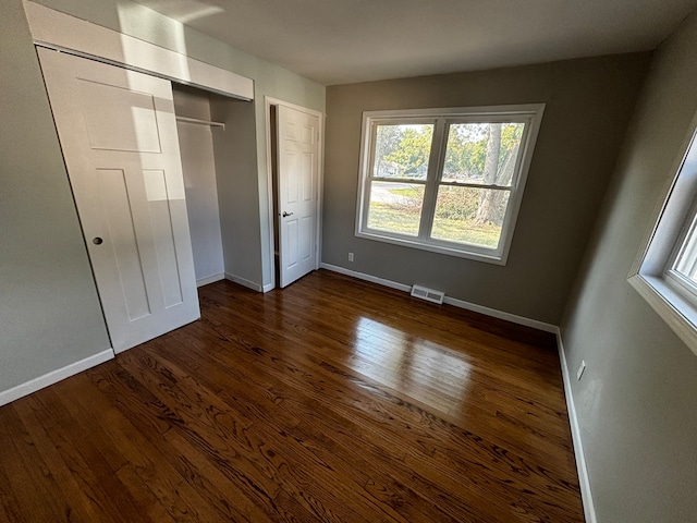 unfurnished bedroom featuring dark hardwood / wood-style floors