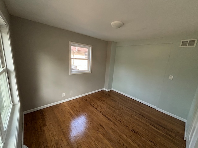 unfurnished room featuring dark hardwood / wood-style floors