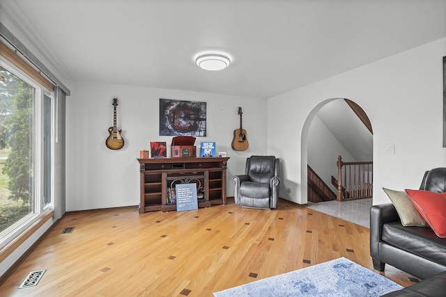 living room with plenty of natural light and hardwood / wood-style floors