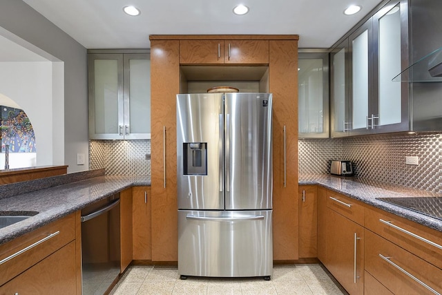 kitchen featuring decorative backsplash, wall chimney exhaust hood, and stainless steel appliances