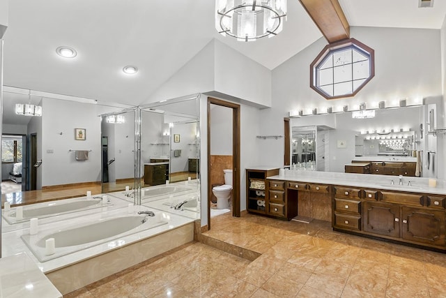 bathroom featuring beam ceiling, a relaxing tiled tub, high vaulted ceiling, toilet, and vanity