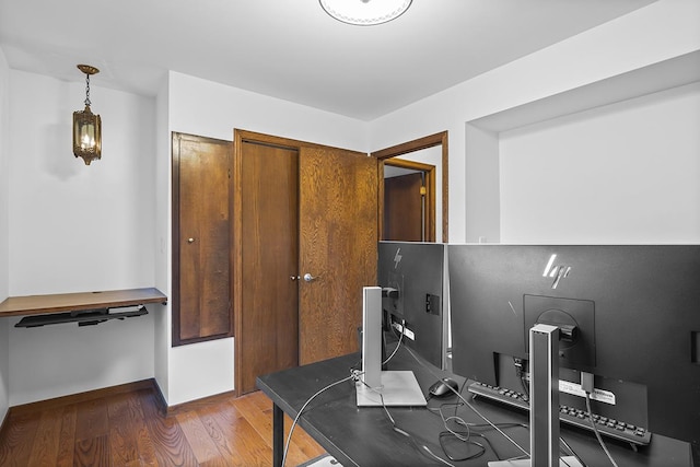 office with dark wood-type flooring