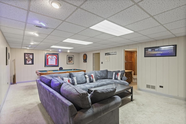 living room featuring a paneled ceiling, light carpet, and pool table