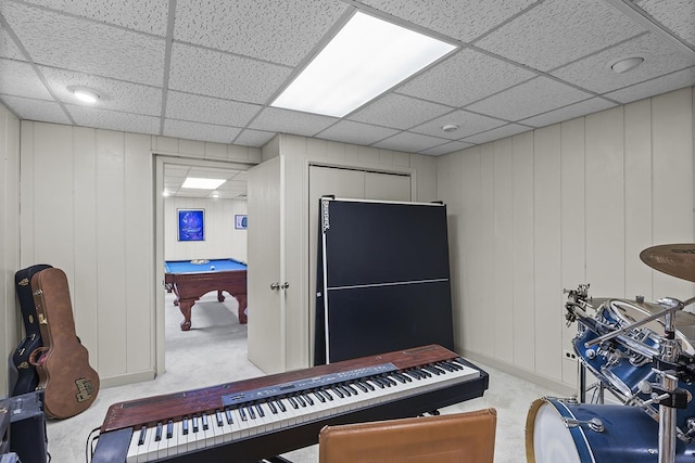 misc room with carpet and a paneled ceiling