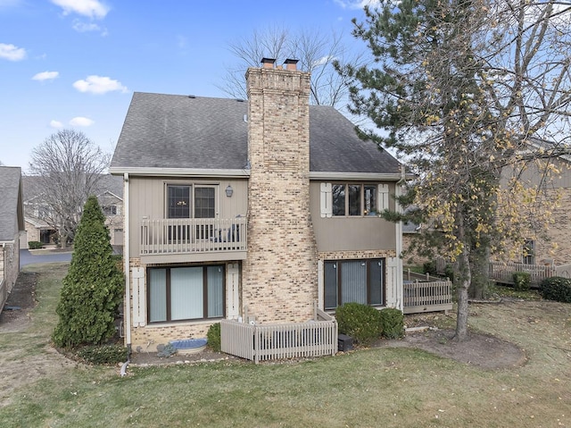 back of property featuring a yard and a balcony