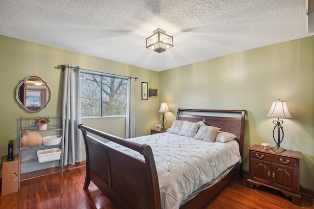 bedroom with a textured ceiling and dark hardwood / wood-style floors