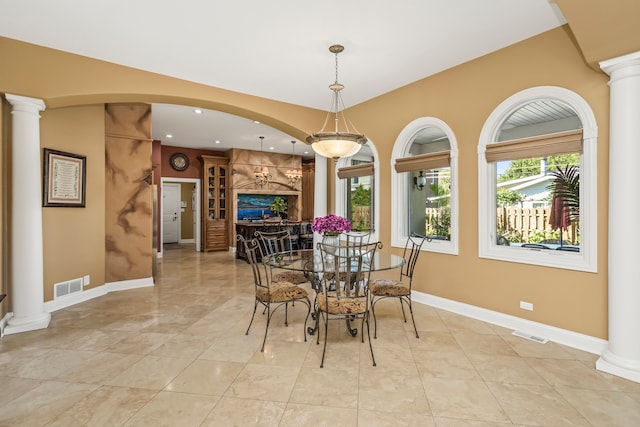 dining area featuring ornate columns