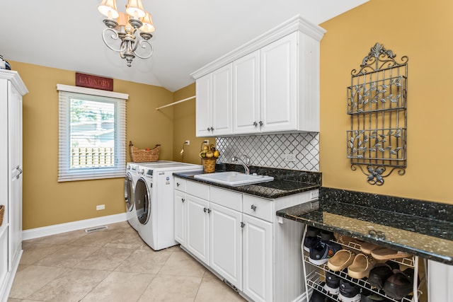 laundry room with cabinets, sink, light tile patterned floors, separate washer and dryer, and a chandelier