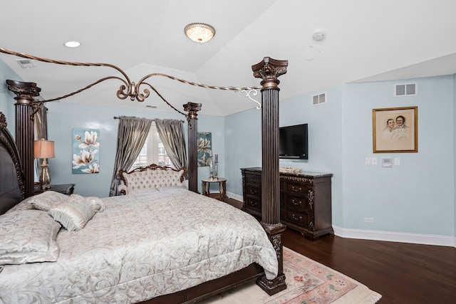 bedroom featuring dark hardwood / wood-style flooring and lofted ceiling