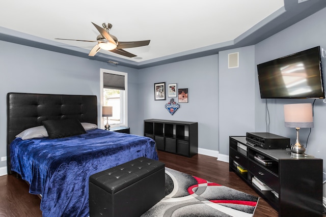 bedroom with ceiling fan and dark hardwood / wood-style floors