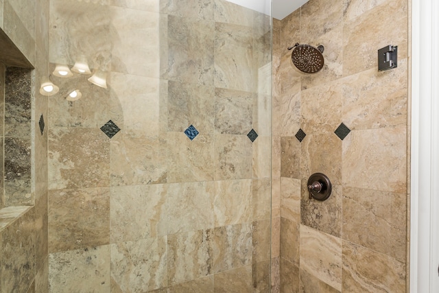 interior details featuring a tile shower