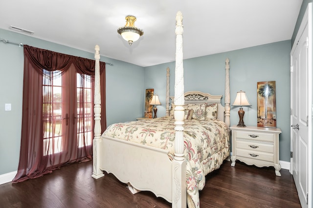 bedroom with dark hardwood / wood-style floors