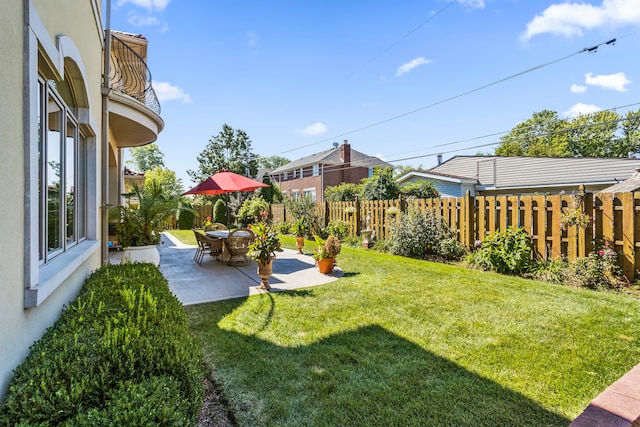 view of yard featuring a balcony and a patio area