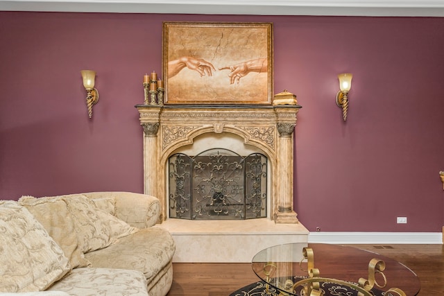 sitting room with hardwood / wood-style flooring and a premium fireplace