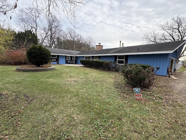 rear view of house featuring a yard