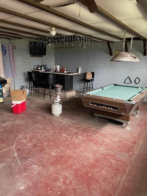 rec room with concrete floors, indoor bar, and billiards