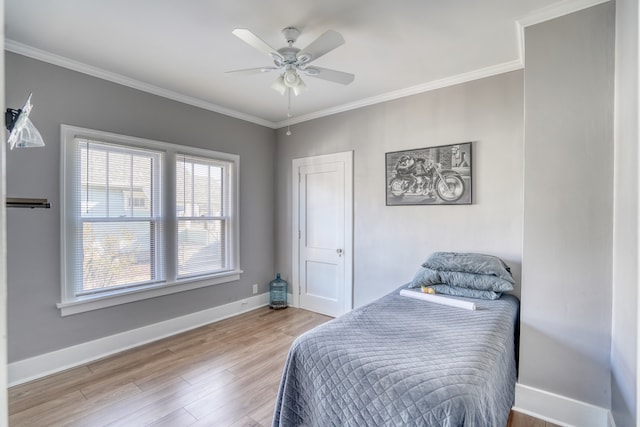 bedroom with ceiling fan, hardwood / wood-style floors, and crown molding