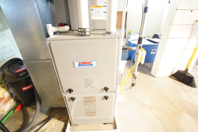 utility room featuring heating unit