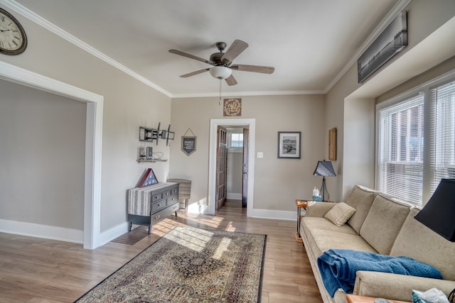 living room featuring crown molding, ceiling fan, and light hardwood / wood-style floors