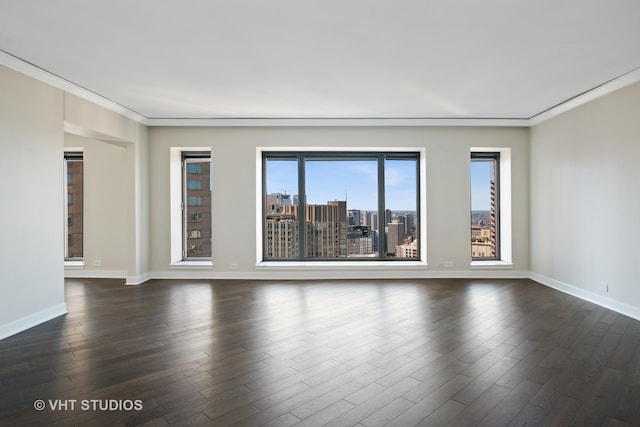 empty room with ornamental molding and dark wood-type flooring