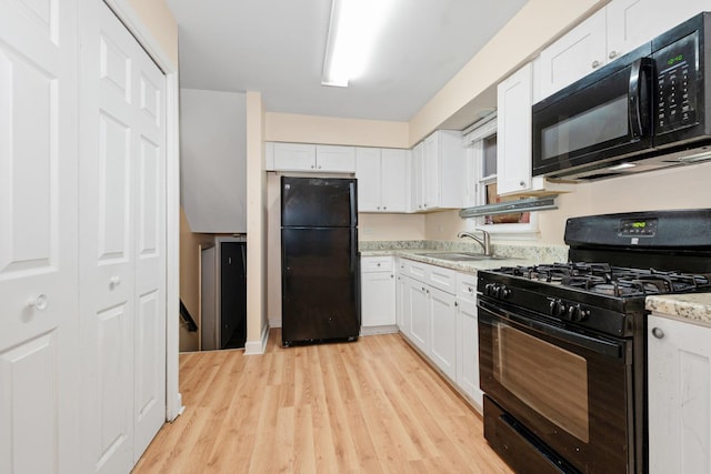 937 E 148th St, Dolton, IL 60419 - kitchen featuring black appliances, light wood-style floors, white cabinetry, and light stone countertops