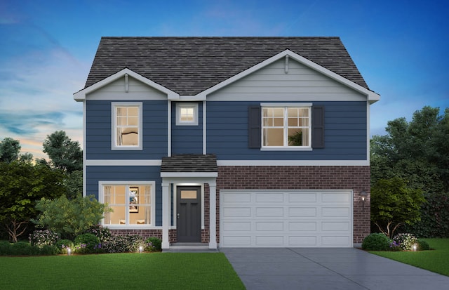 view of front of property featuring a lawn and a garage