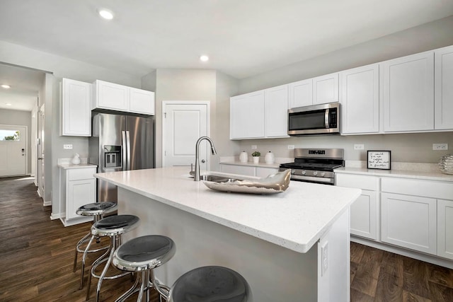 kitchen with white cabinetry, a kitchen island with sink, and appliances with stainless steel finishes