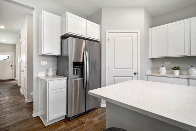 kitchen with white cabinets, dark hardwood / wood-style floors, and stainless steel fridge with ice dispenser