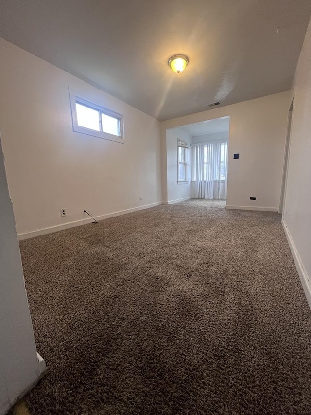 carpeted empty room featuring a healthy amount of sunlight