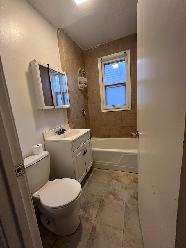 full bathroom with vanity, toilet, and tiled shower / bath