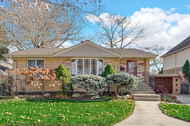 view of front of property with a front yard and a garage