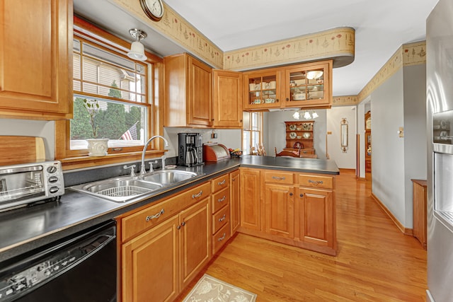 kitchen featuring sink, black dishwasher, stainless steel fridge with ice dispenser, kitchen peninsula, and light wood-type flooring