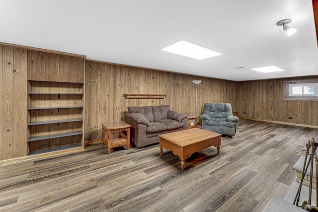 living room with wood-type flooring and wooden walls