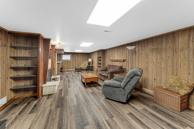 living room with wooden walls and hardwood / wood-style flooring