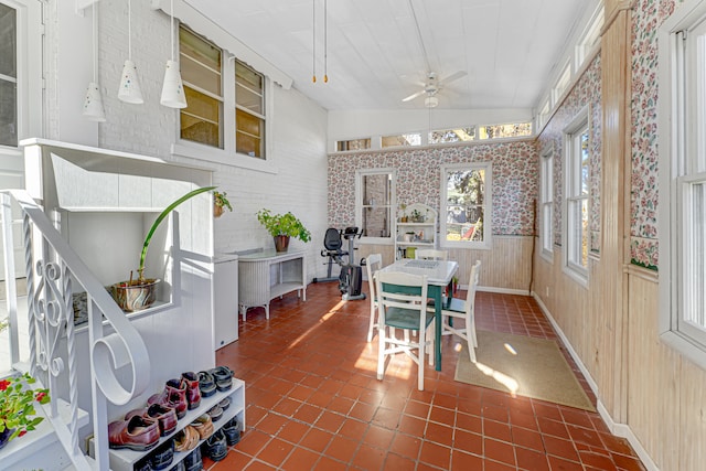 sunroom featuring ceiling fan and lofted ceiling